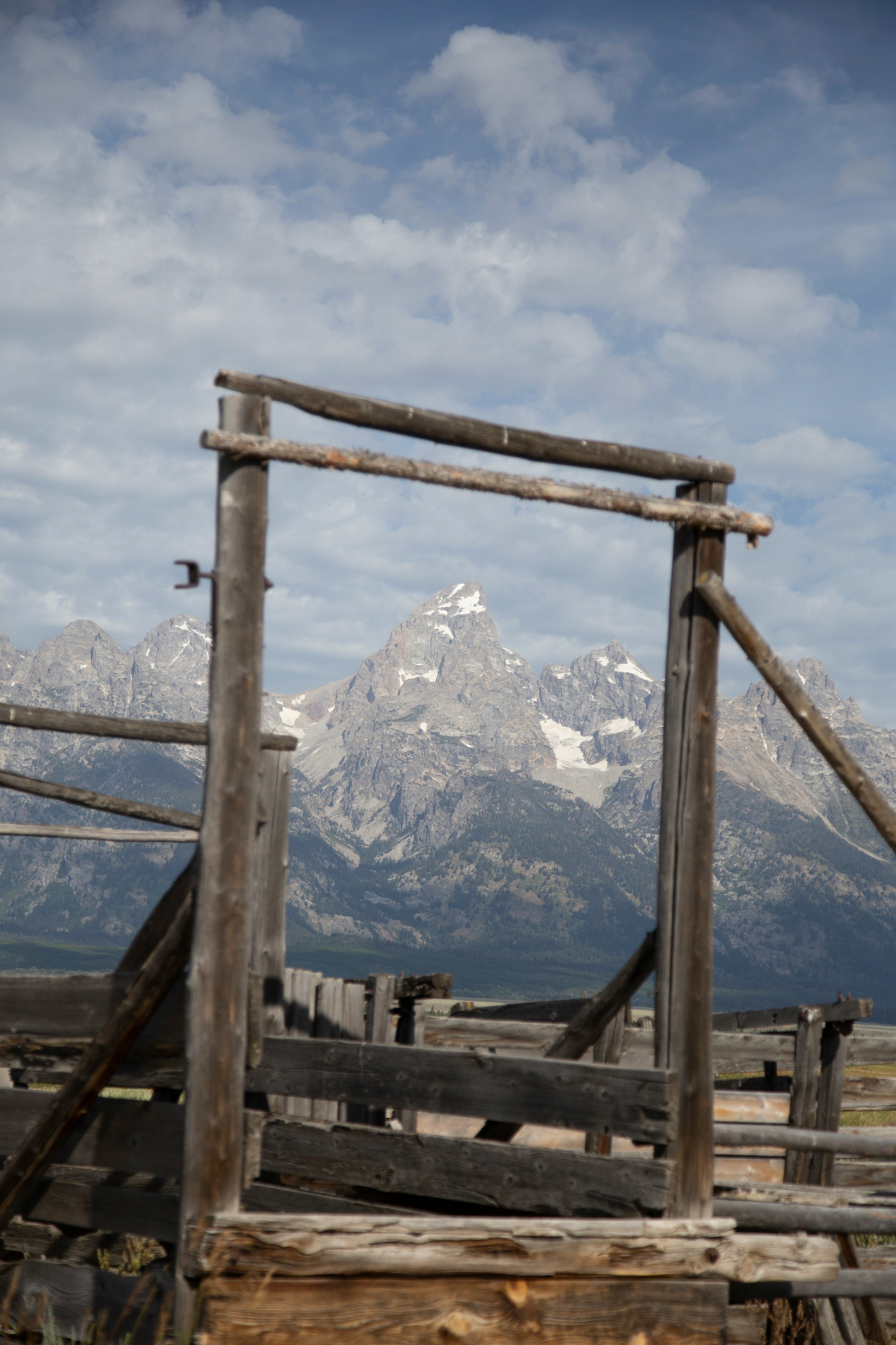 brown wooden frame near snow covered mountain during daytime